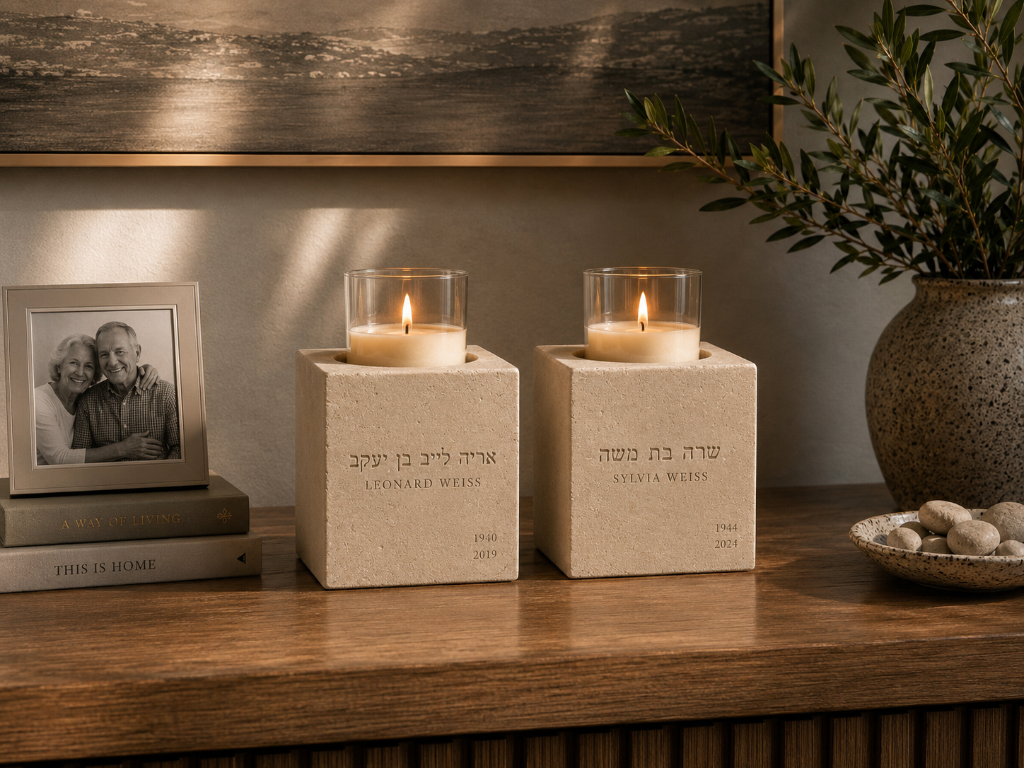 Two memorial stones side by side on a credenza — one for each parent — with a family photograph between them.